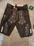 Dark  pants with white embroidery on a textured surface
